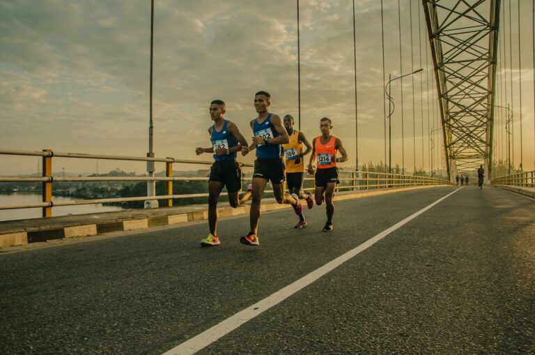 four men running on asphalt floor
